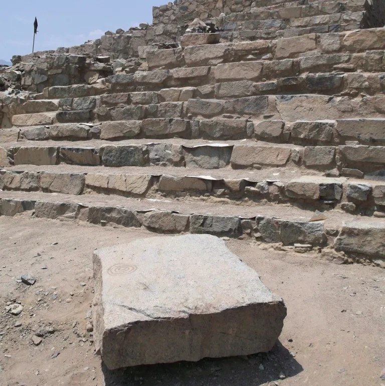 Stone staircase and carved spiral petroglyph at Caral in the Supe Valley, Peru, the oldest city in the Americas.