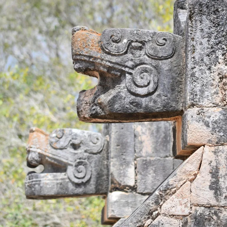 Stone serpent head carvings at the Temple of the Warriors entrance, Chichén Itzá, Yucatán, Mexico