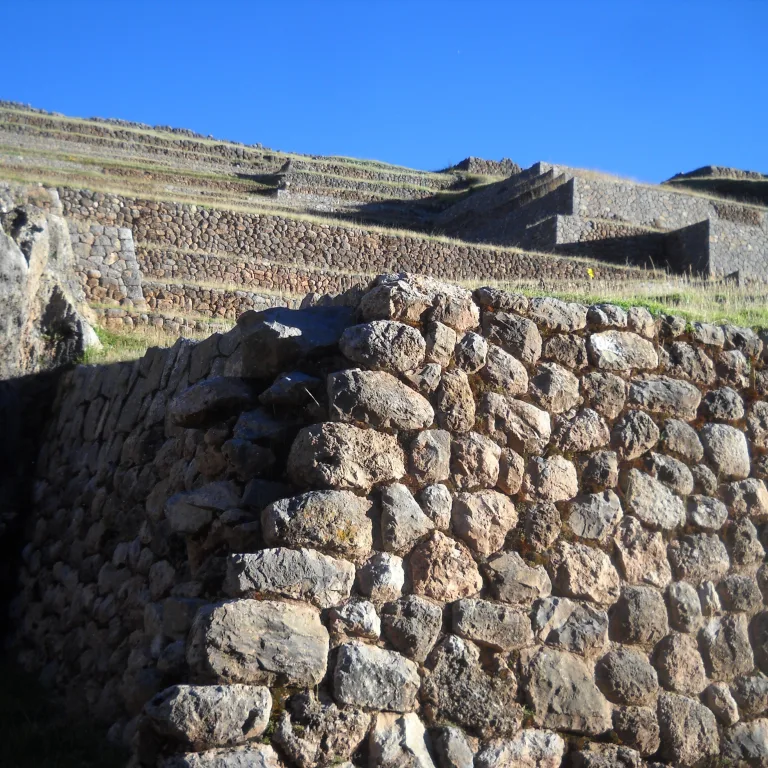 Close-up of dry stone Inca walls and terracing at Chinchero archaeological site in the Sacred Valley.