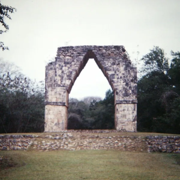 The monumental arch marking the entrance to Kabah, located at the end of a raised stone sacbe road through the Yucatán jungle.