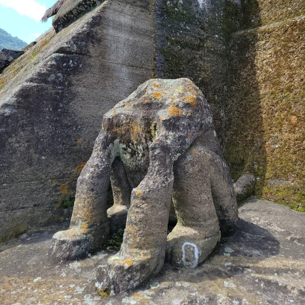 Weathered jaguar sculpture carved from volcanic rock at the Malinalco cliff‑side temple (Aztec site in Mexico), head missing