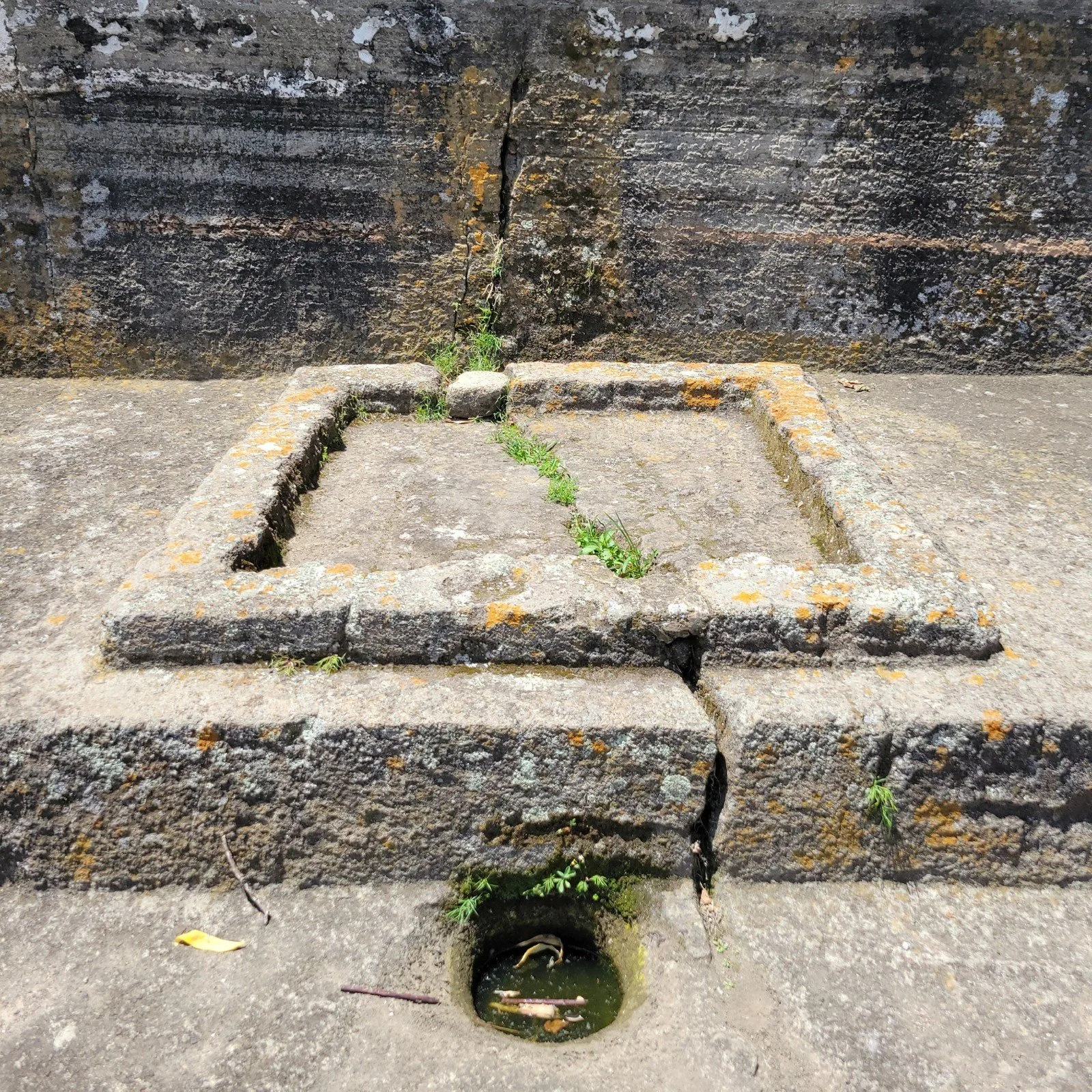 Excavated temple chambers at Malinalco with ceremonial platforms and interpretive signage at the Aztec warrior sanctuary