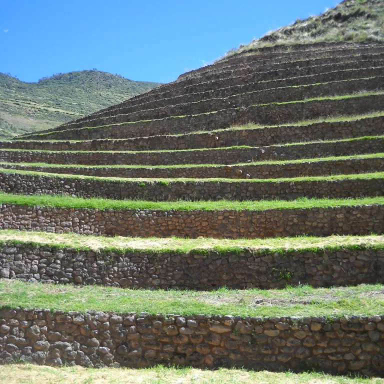 Close-up view of Moray’s Inca agricultural terraces showing detailed stonework and green vegetation under blue skies
