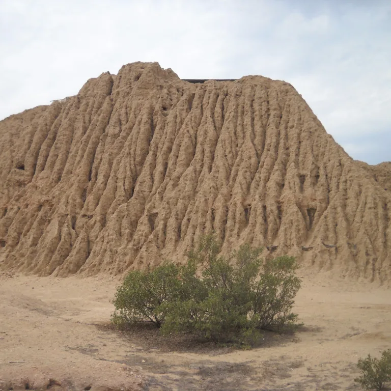 View of the heavily eroded adobe walls of Huaca Larga, the largest pyramid at Túcume