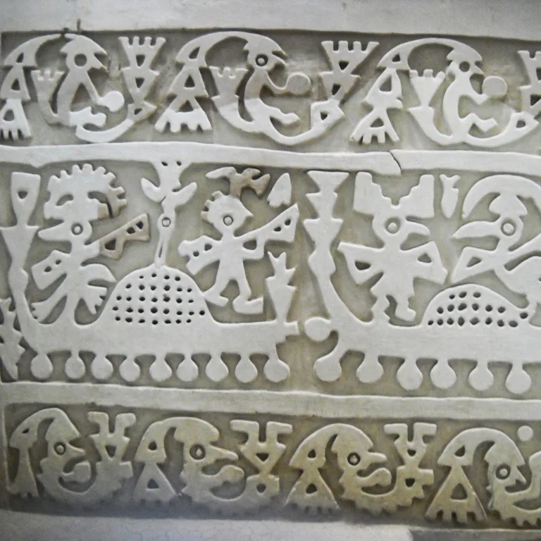 Lambayeque frieze at Huaca Las Balsas, showing stylized figures in boats with marine iconography at the Túcume ruins