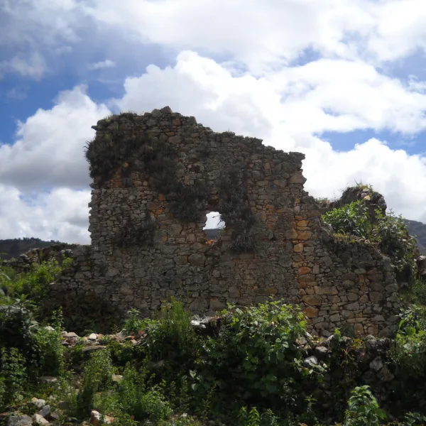 Weathered stone wall with window opening at Viracochapampa ruins in Huamachuco, Peru.