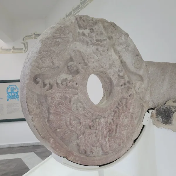 Intricately carved ballcourt ring with glyphs and circular hole from the Xochicalco Site Museum.