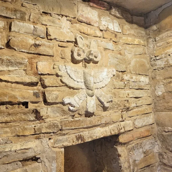 Carved owl relief inside a Zapotec tomb chamber at Zaachila archaeological site in Oaxaca.