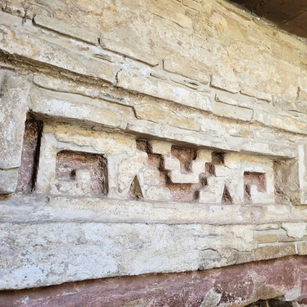 Zapotec geometric stone relief on the interior wall of a tomb at Zaachila archaeological site in Oaxaca.