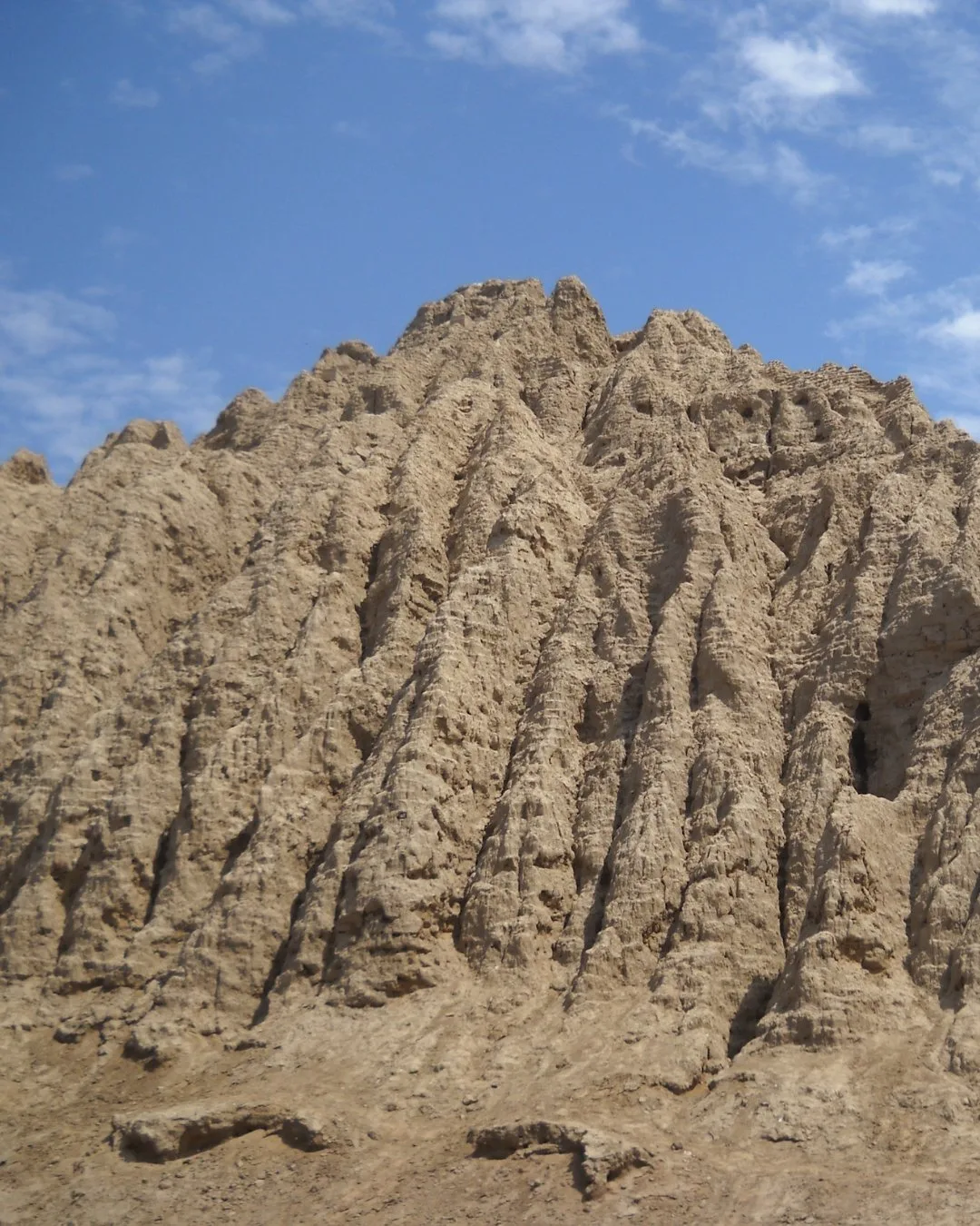 Eroded adobe pyramid huaca at Batán Grande in the Lambayeque Valley Peru, part of the ancient Sicán culture archaeological site.