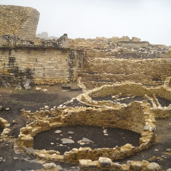 Circular stone enclosures at Kuélap fortress in northern Peru, built by the Chachapoya culture on a high mountain ridge.