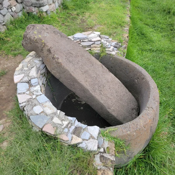 Close-up of carved stone basin containing an upright monolith at the Xochitécatl archaeological site