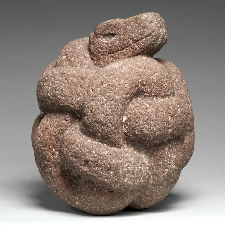 Aztec stone sculpture of a coiled serpent, a powerful symbol of fertility and earth, commonly found in the architecture of Tenochtitlan.