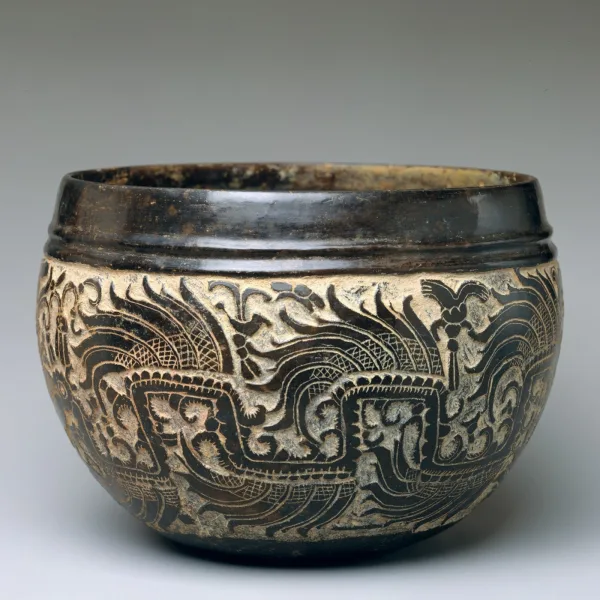 Classic Maya art carved blackware bowl featuring a complex mythological scene of emergence from the underworld, reflecting Teotihuacan influence.
