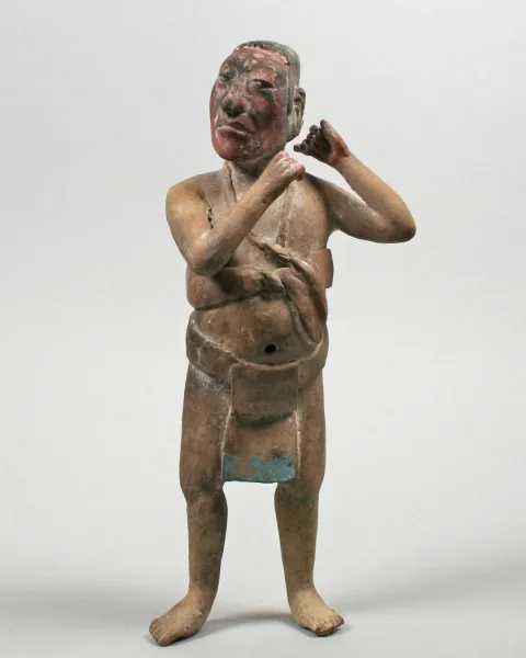 Classic Maya art ceramic figurine of a standing male noble or official, dating to the 7th–8th century and retaining traces of original pigment.