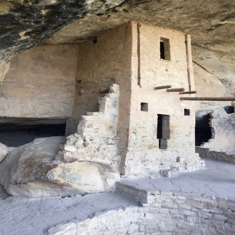 Balcony House at Mesa Verde National Park, showing an Ancestral Pueblo room block with preserved plastered walls, beam openings, and a kiva area beneath a sandstone alcove.