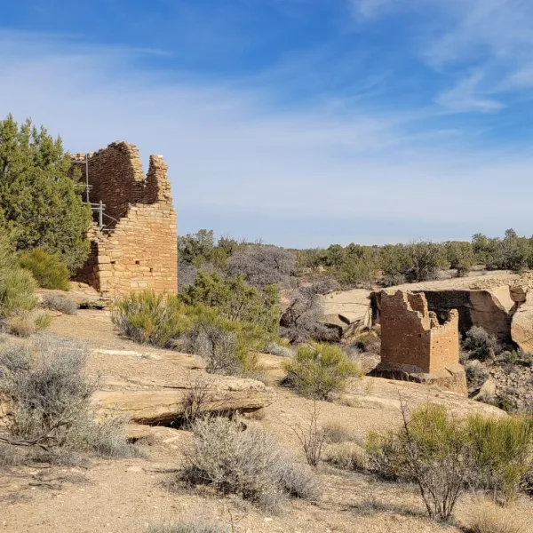 Holly House and Holly Tower at the Holly Group, with Holly House on the canyon rim and Holly Tower built on a sandstone boulder below.