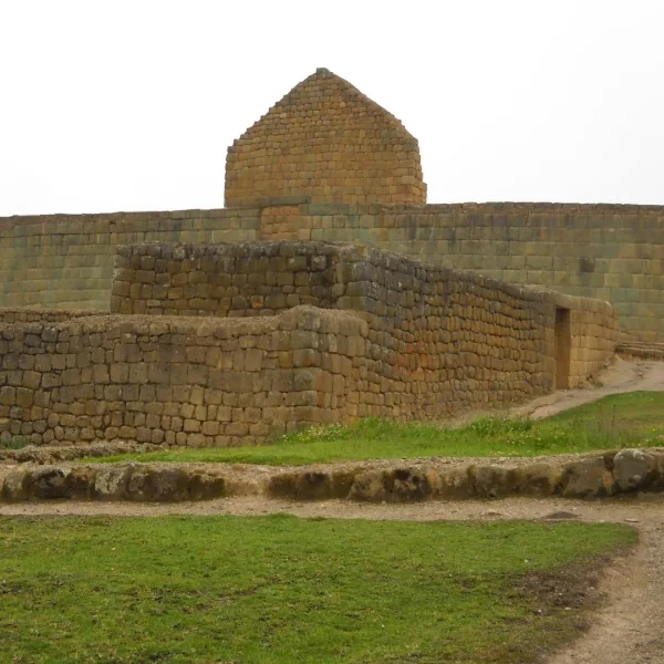 Side view of the Temple of the Sun at Ingapirca in Cañar, Ecuador, with stone walls and a walkway in the foreground.