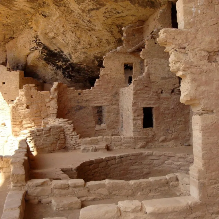 Stone rooms and walls of an Ancestral Puebloan cliff dwelling at Mesa Verde in Colorado, built beneath a sandstone alcove.