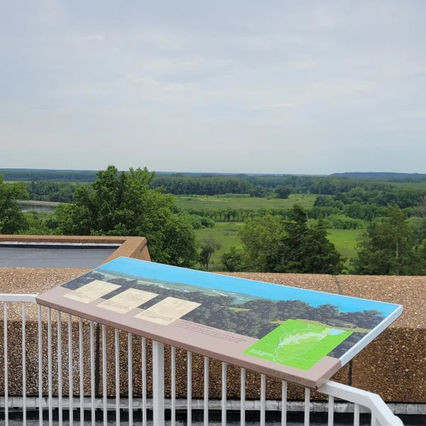 Dickson Mounds Museum overlook in Lewistown, Illinois, with an interpretive panel and a wide view across the Illinois River valley.