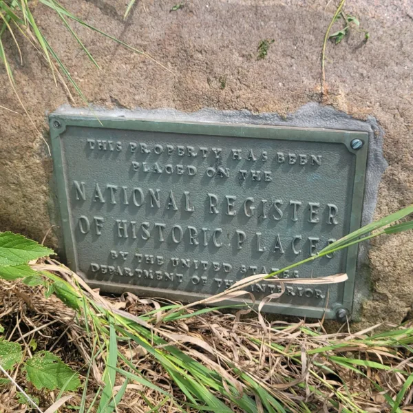 National Register of Historic Places plaque on Ogden Mound at the Ogden-Fettie Mounds, partially surrounded by grass and soil.