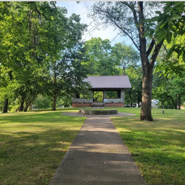 Bandstand shelter on top of Rockwell Mound in Havana, Illinois, surrounded by trees on the grassy summit of the Havana Hopewell earthwork.