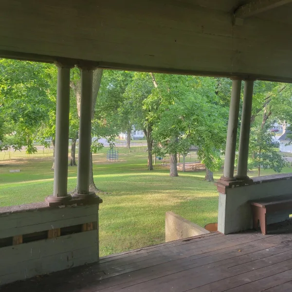 View from the bandstand shelter on Rockwell Mound in Havana, Illinois, looking down the grassy mound slope toward Rockwell Park.