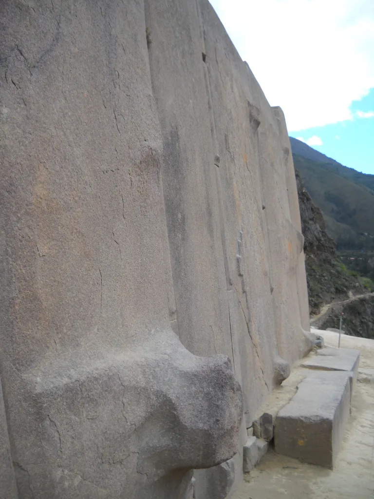 Wall of Six Monoliths at the Temple of the Sun in Ollantaytambo, Peru, formed from six massive upright pink granite blocks fitted together on the upper temple terrace.