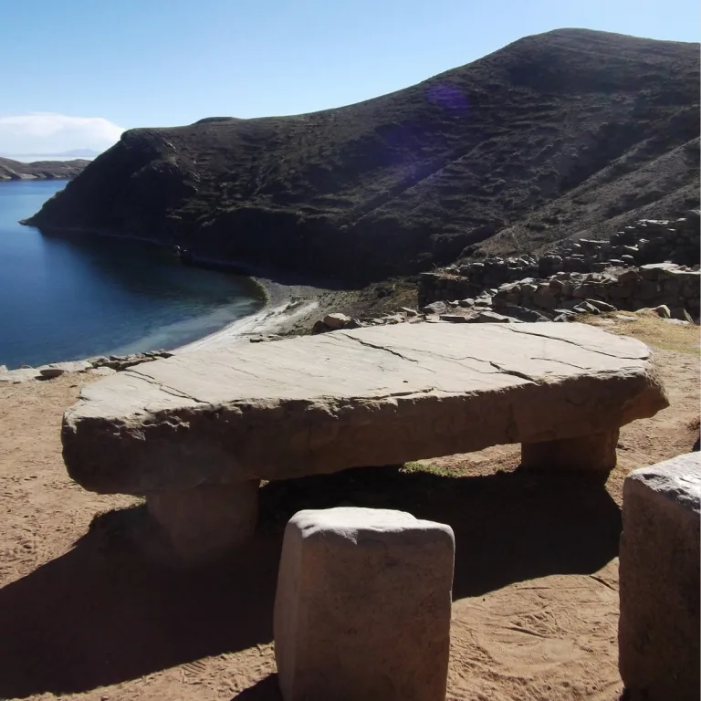 A large stone table near Chincanna on Isla del Sol in Bolivia, overlooking a sheltered bay of Lake Titicaca.