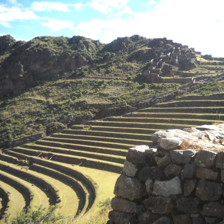 Sweeping Inca agricultural terraces at Pisac in Cusco, Peru, curving across the mountainside below the Qallaqasa sector.