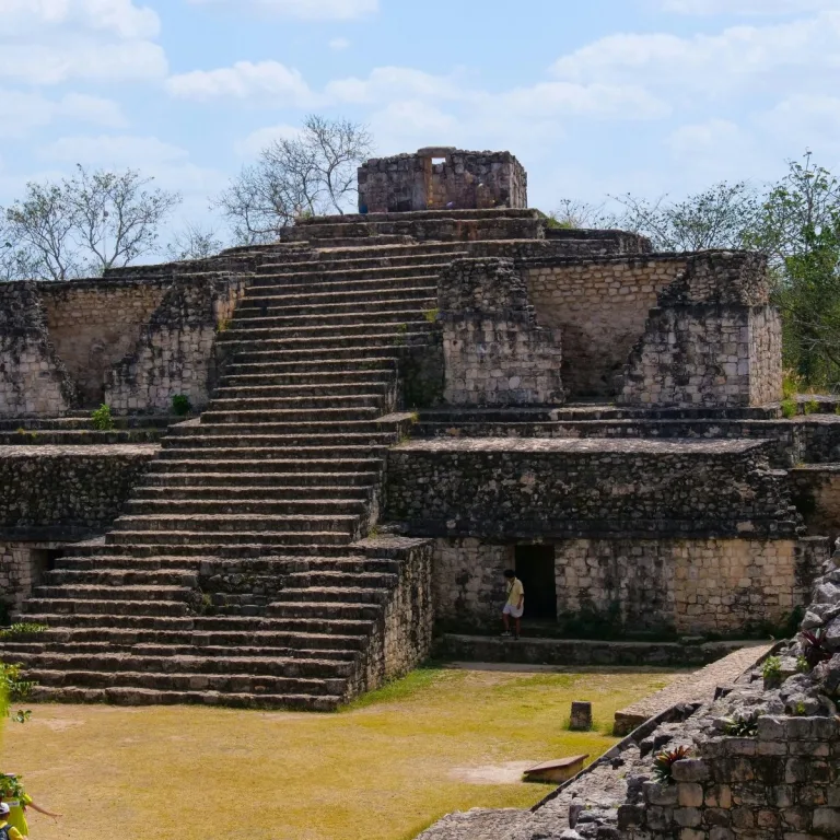 The broad central staircase of Structure 16, the Oval Palace at Ek Balam in Yucatán, Mexico, climbs past lower rooms to a small upper building.