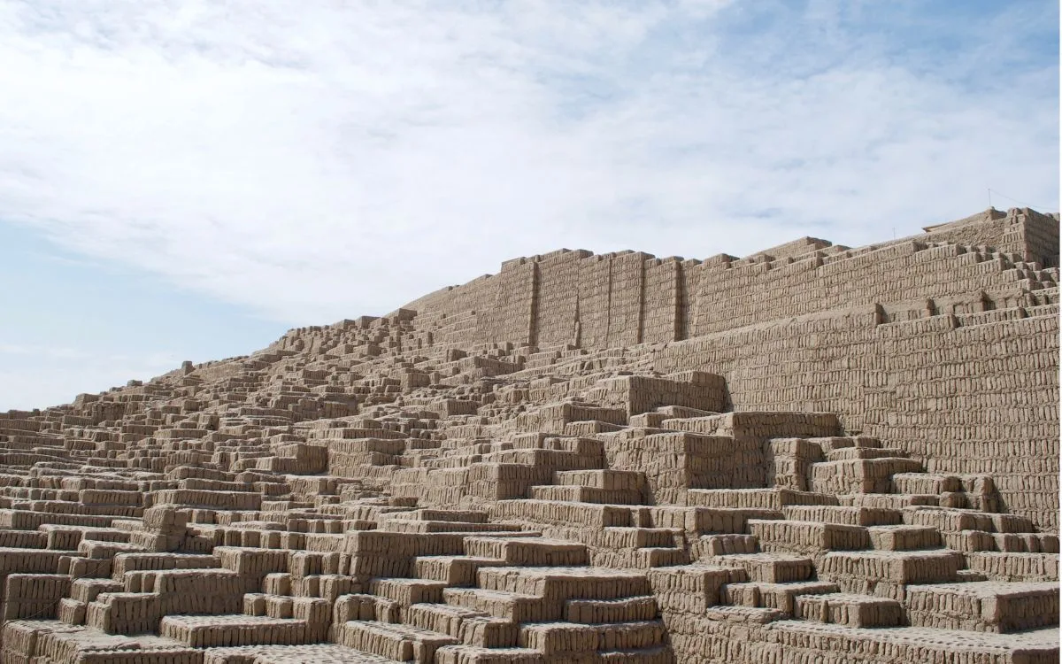 The Gran Pirámide at Huaca Pucllana in Miraflores, Lima, Peru, showing massive stepped terraces and walls constructed from vertically arranged adobe bricks.