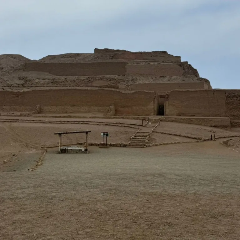 The Temple of the Sun at Pachacamac, with stacked adobe terraces and a narrow entrance approached by stone steps.