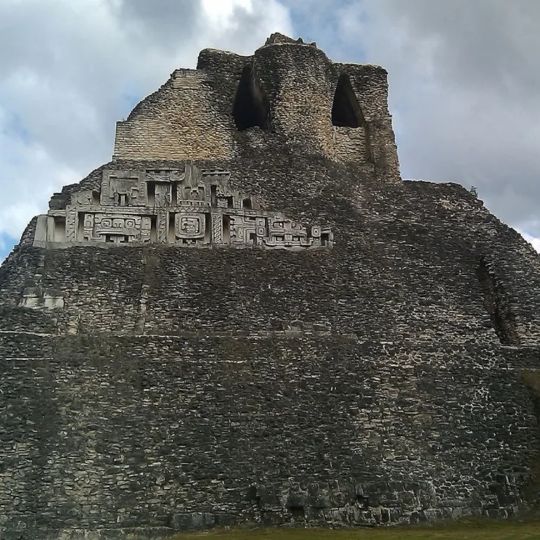 El Castillo at Xunantunich in Cayo District, Belize, showing the monumental Maya pyramid and reconstructed stucco frieze across its upper façade.